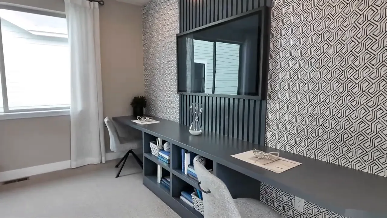 Residence 2 upstairs loft flex space with built-in desk, window light, and patterned accent wall in Painted Prairie, Aurora Colorado