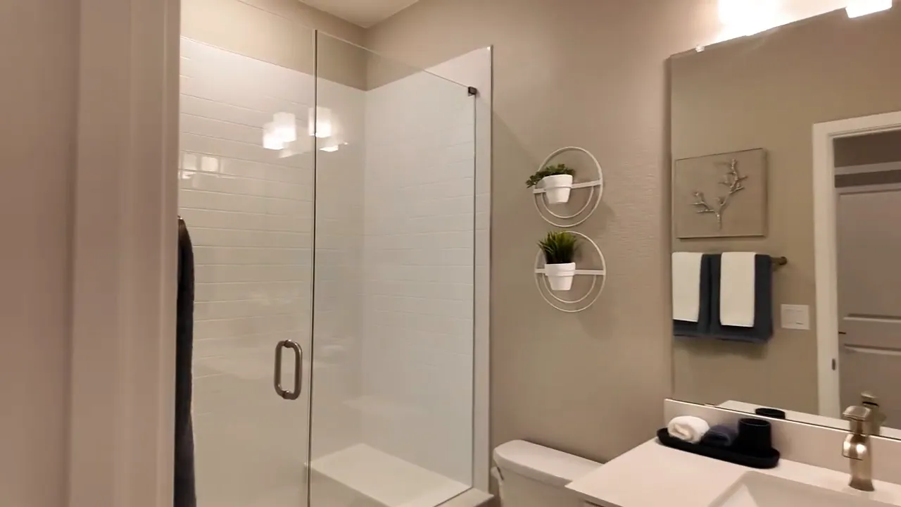 Painted Prairie Residence 2 finished basement bathroom with walk-in shower and vanity sink