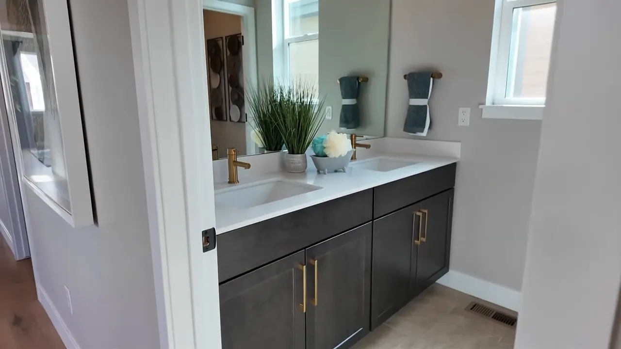 Upstairs laundry room folding counter and dark cabinetry in Painted Prairie model home