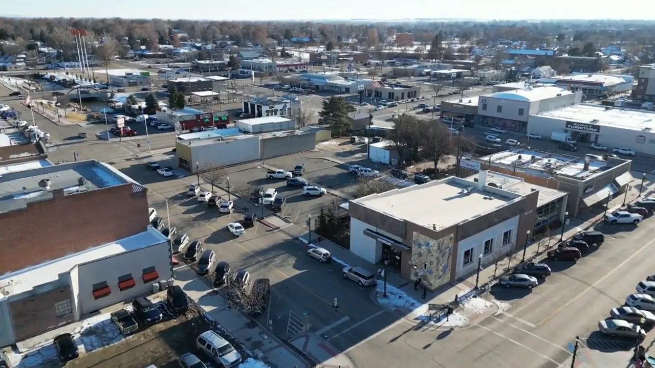 aerial view of a retail center with parking lots and surrounding commercial buildings