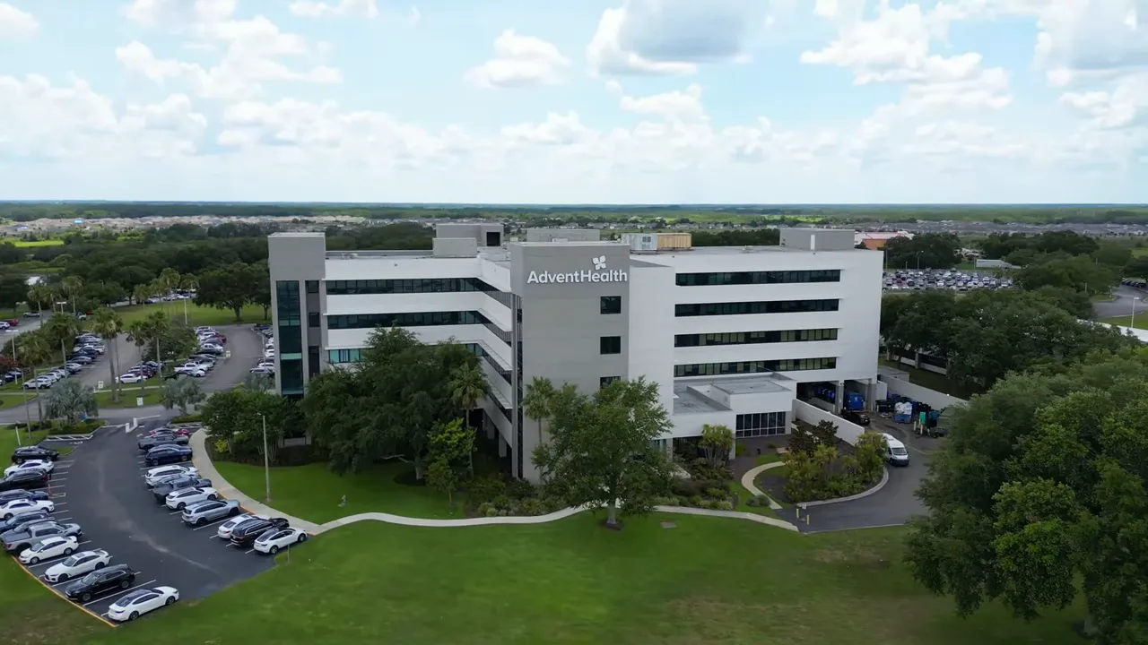 clear aerial photo of AdventHealth building with parking and green lawn