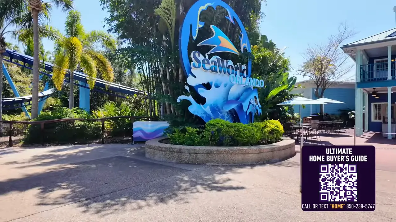 SeaWorld Orlando sign and nearby ride track with tropical landscaping