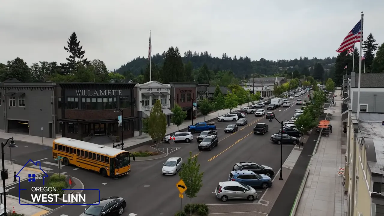 Historic downtown street in West Linn with shops cars and a school bus