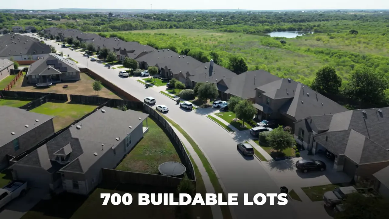 Aerial view of neighborhood streets and homes with text showing 700 buildable lots