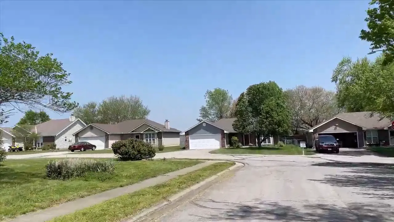 Fox Ridge Warrensburg MO residential street with similar home designs, lawns, and driveways