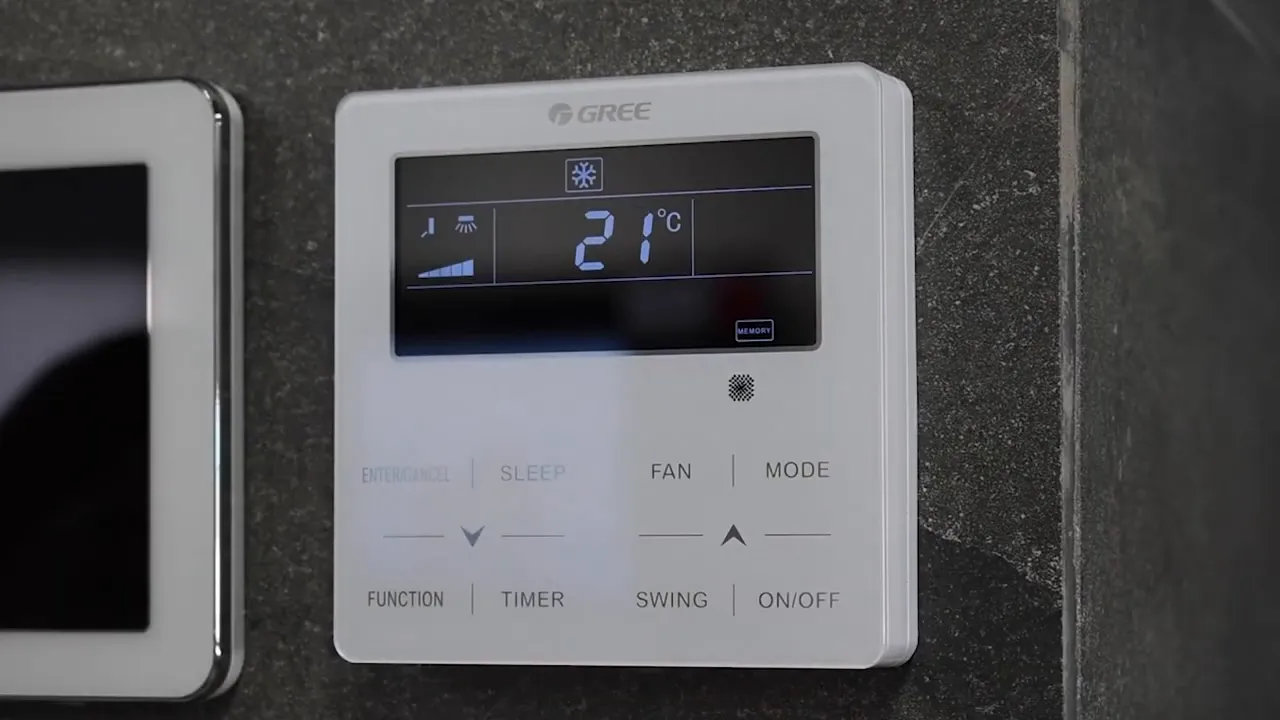 Hand pressing a button on a wall thermostat