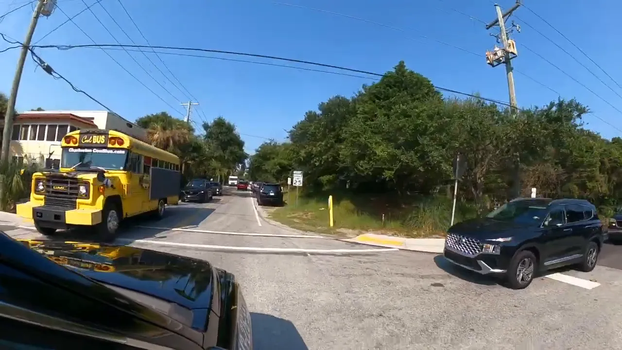 Road traffic in Summerville SC area with bus and cars on a sunny day
