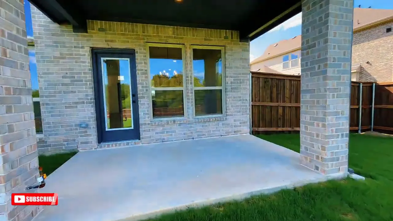 Covered patio with concrete slab brick columns and back door