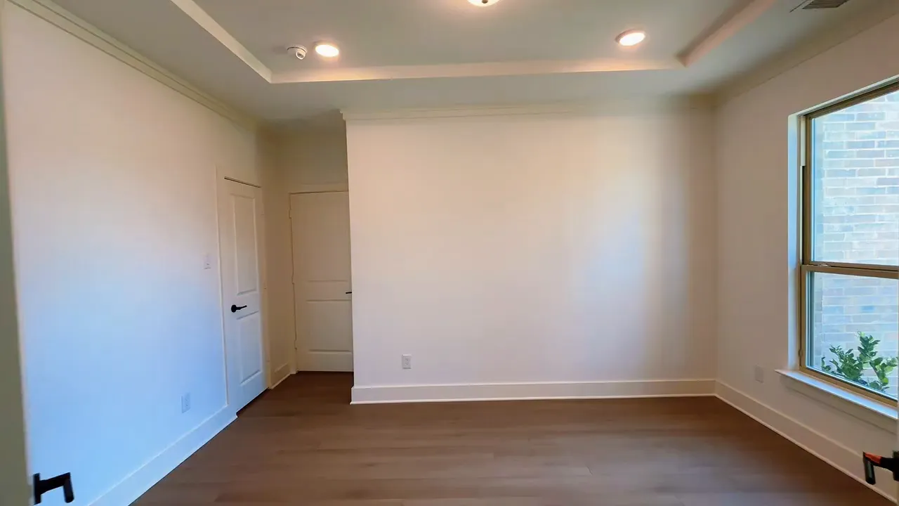Dedicated study with tray ceiling recessed lights and window