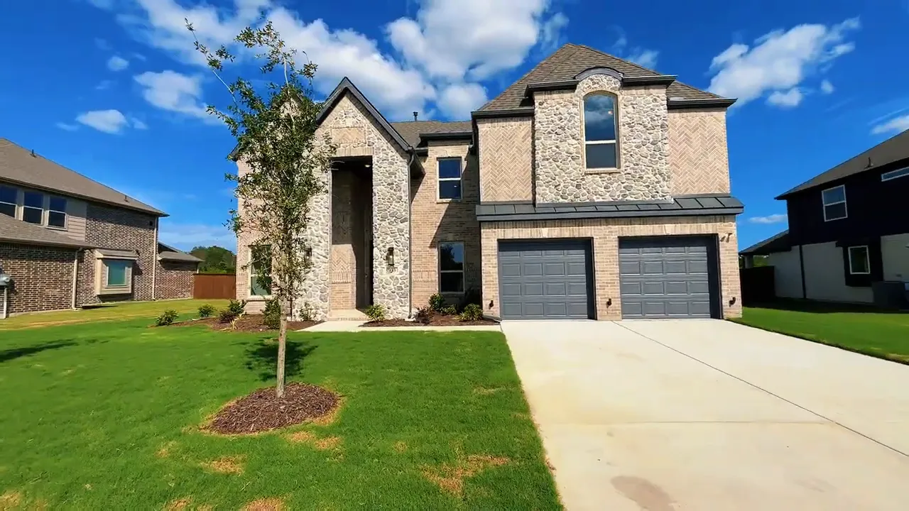Front exterior of large brick two story home with long driveway and front lawn