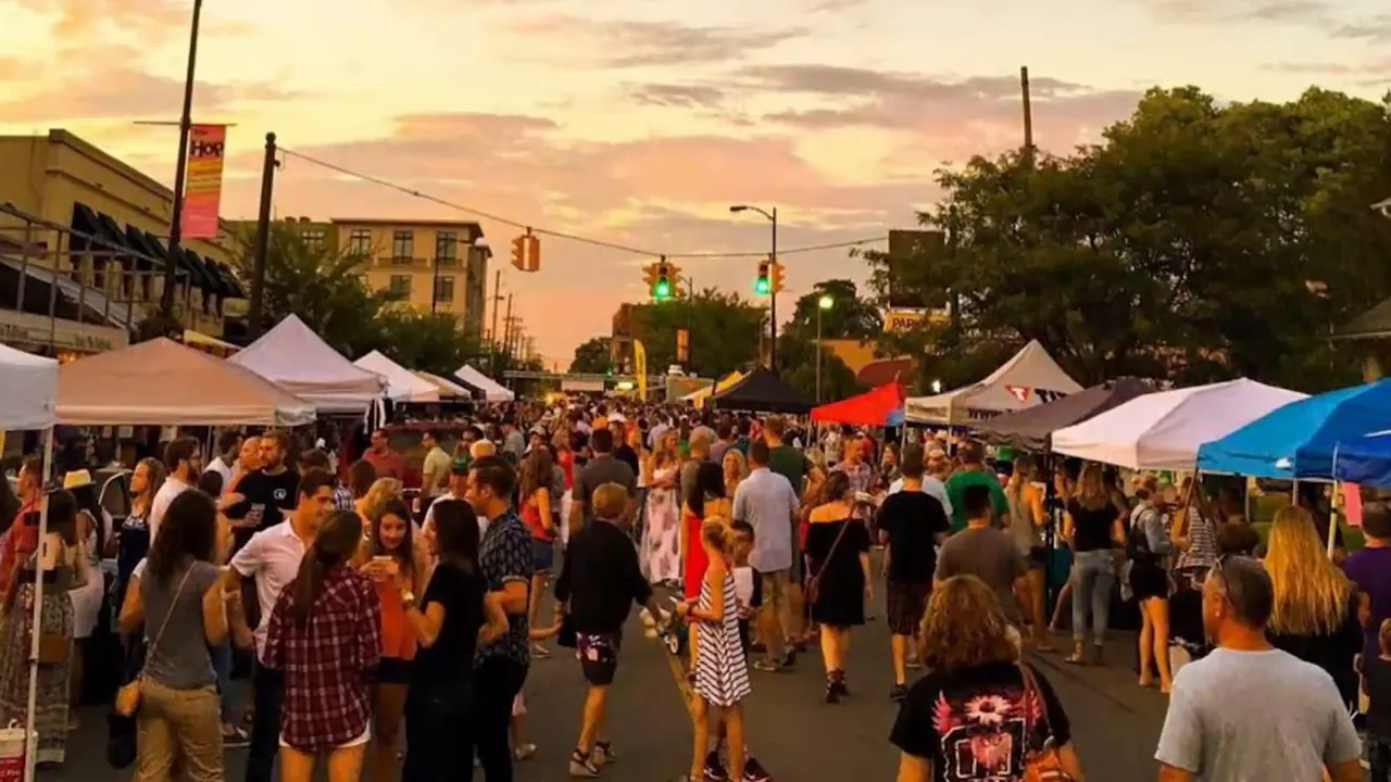 Crowded Grandview Hop street festival with vendor tents at sunset