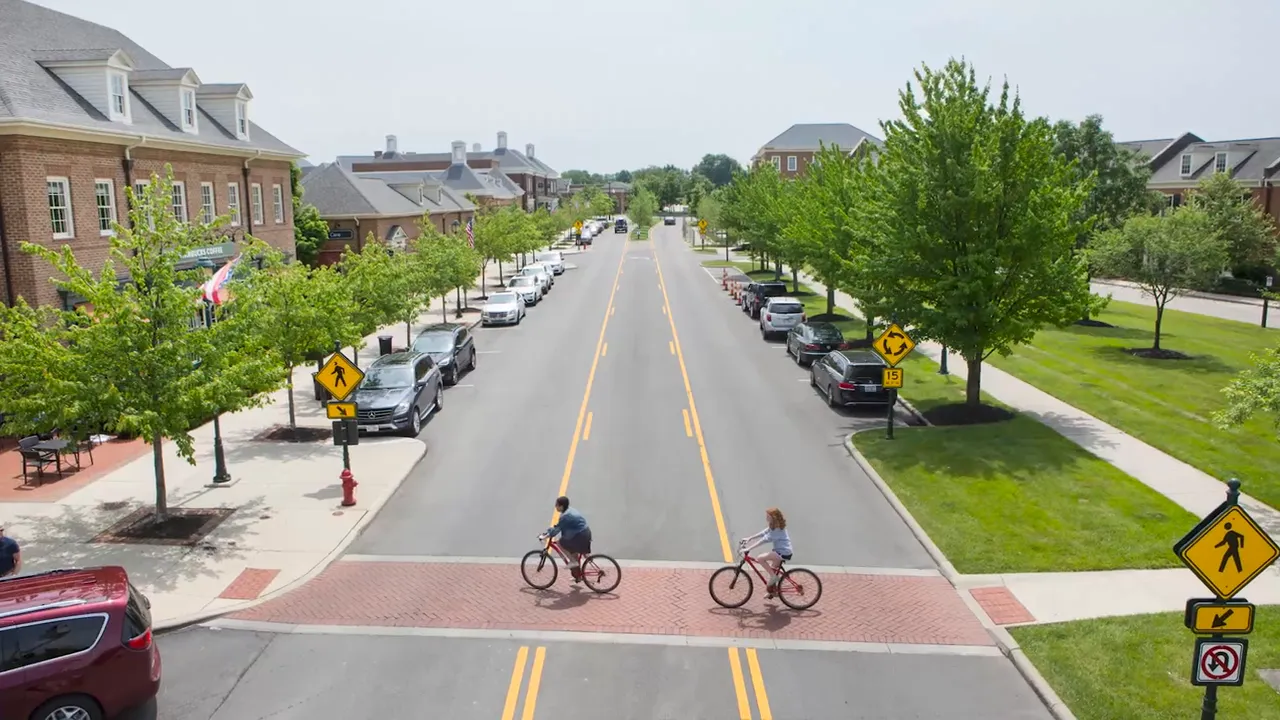 Cyclists crossing Market Street in New Albany