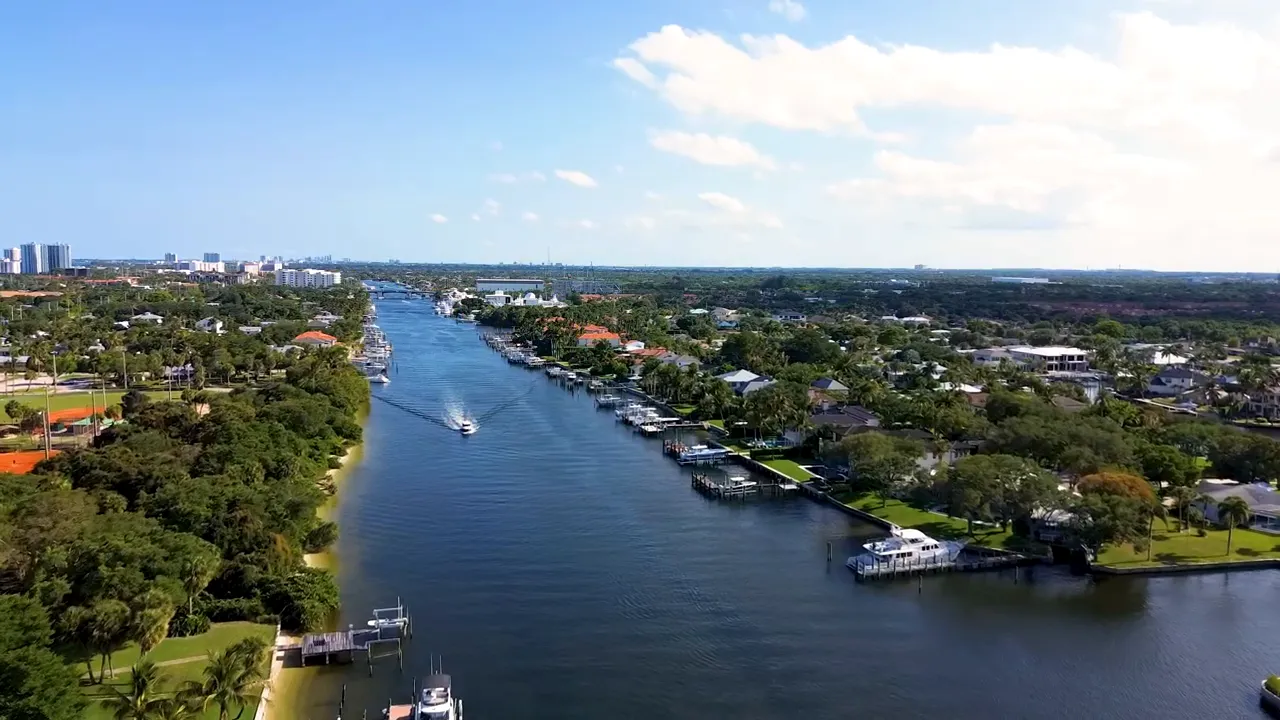 Aerial view of a canal with docks and homes in Palm Beach County