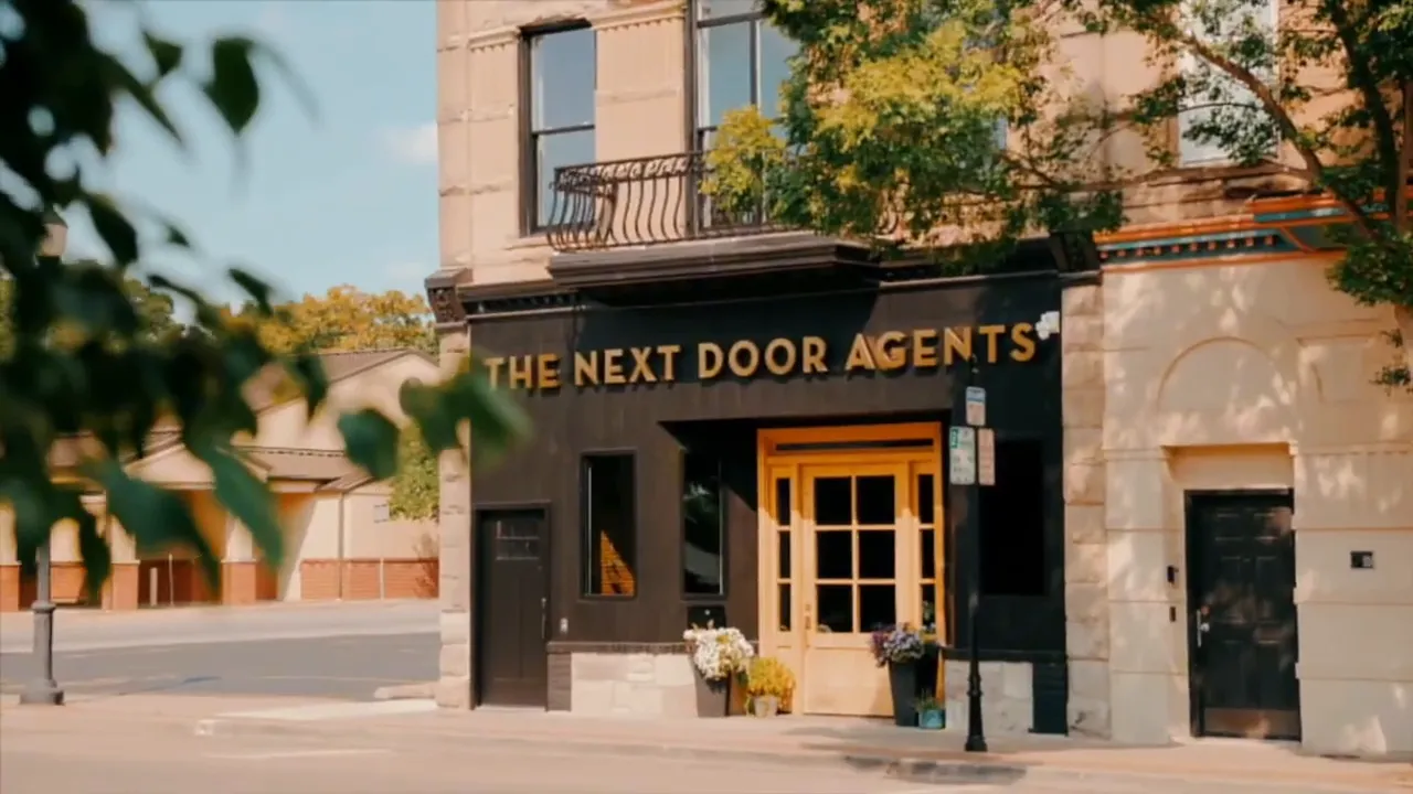 Clear view of 'The Next Door Agents' storefront in downtown Warrensburg