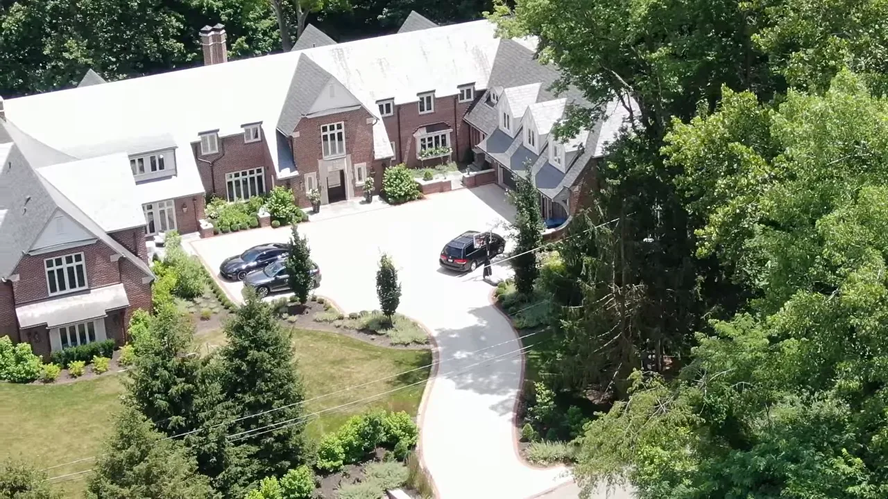 Aerial view of a luxury neighborhood in Williams Creek Indianapolis surrounded by trees and winding roads