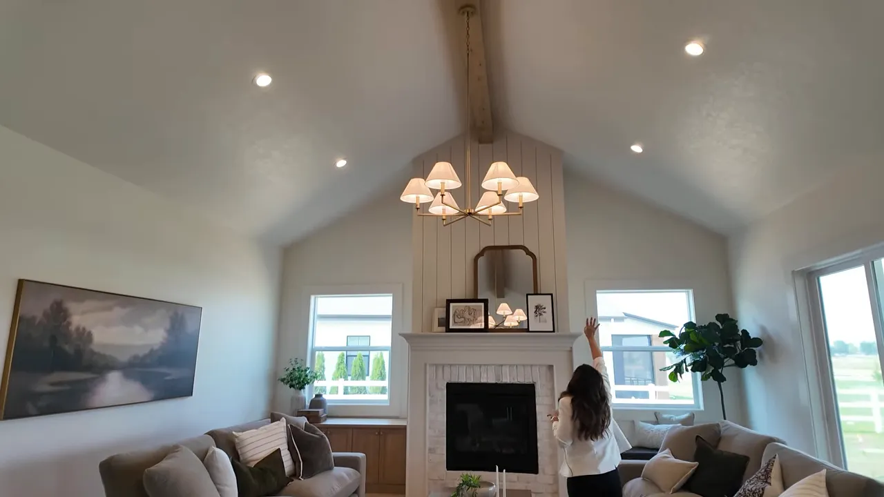 Great room with vaulted ceiling wood beam fireplace and large windows