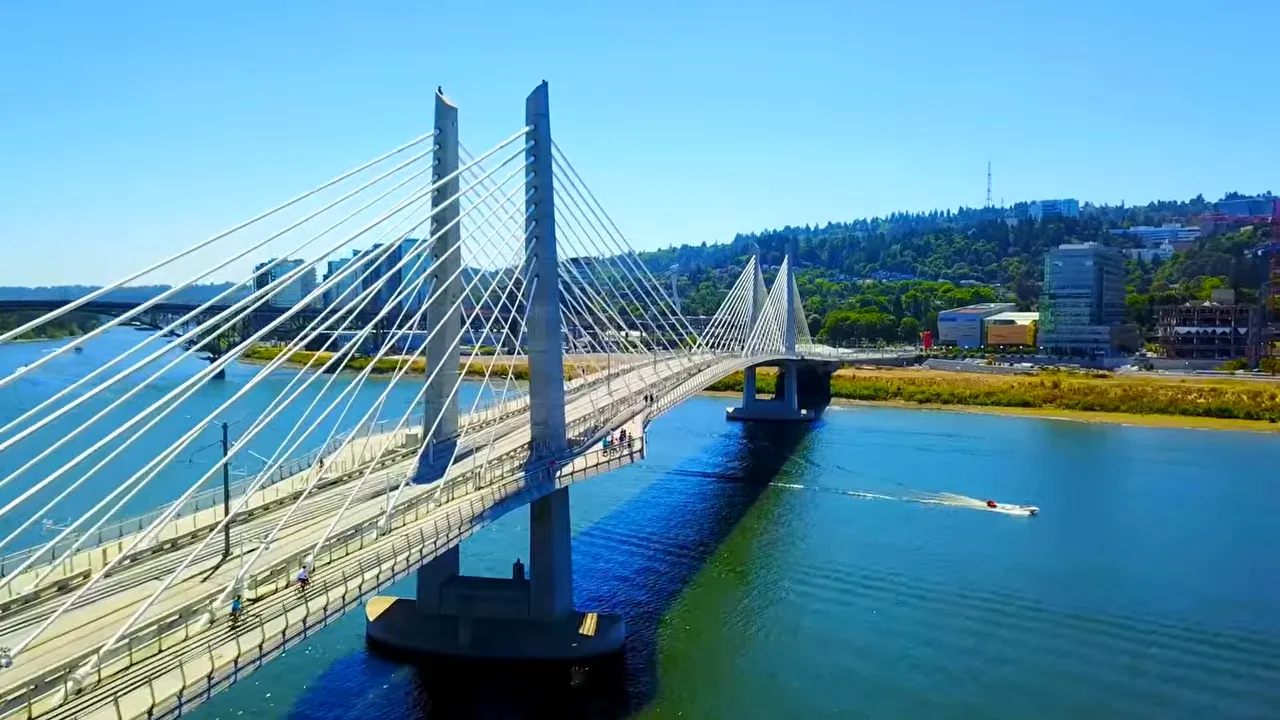 Cable-stayed bridge crossing a sunny river in Portland
