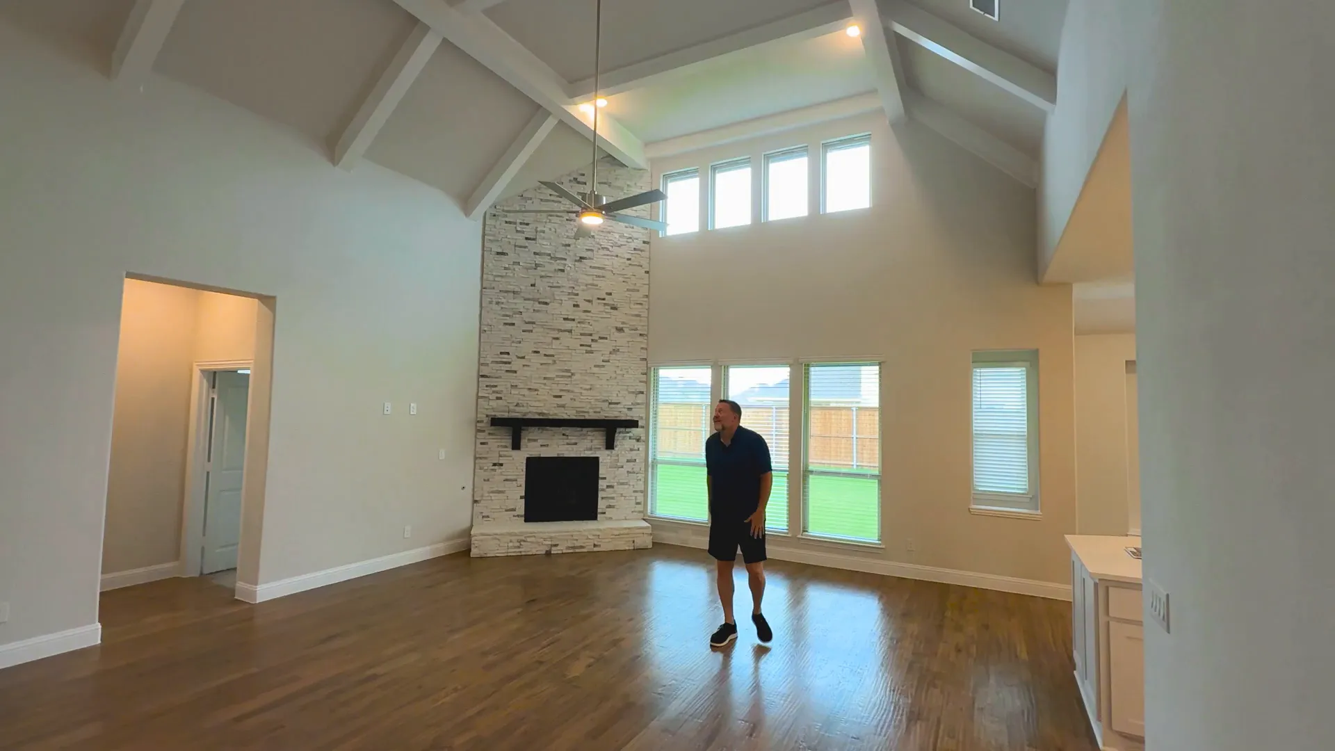 Living room with cathedral ceilings and stacked stone fireplace