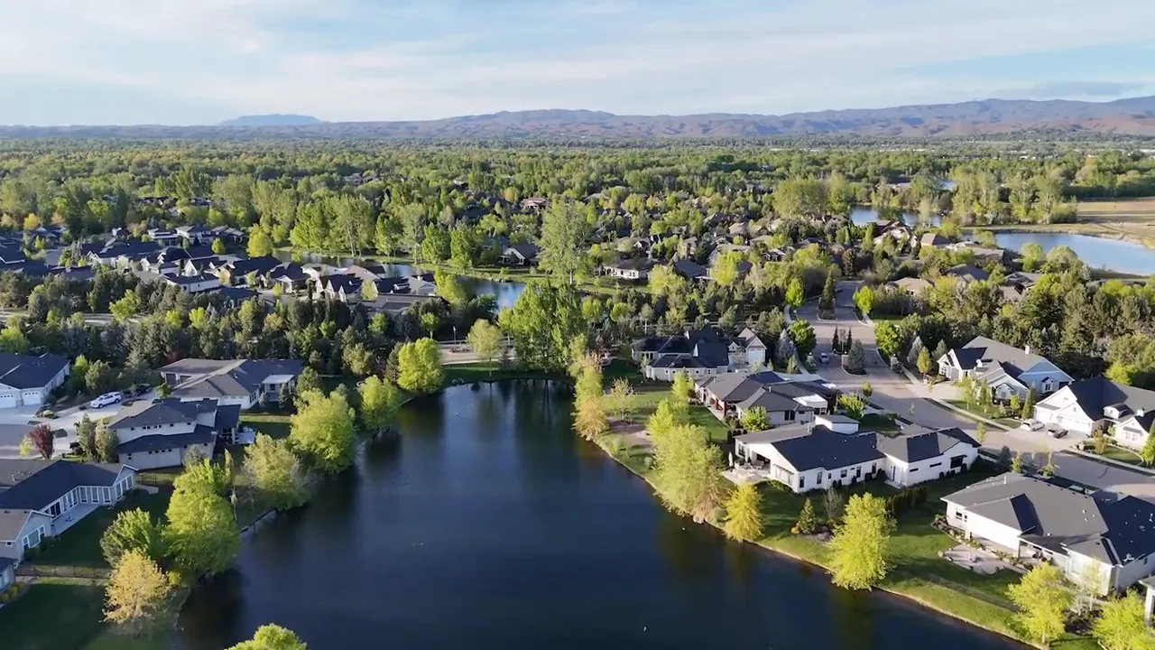 Aerial view of a curving road between two blue lakes in a master planned neighborhood