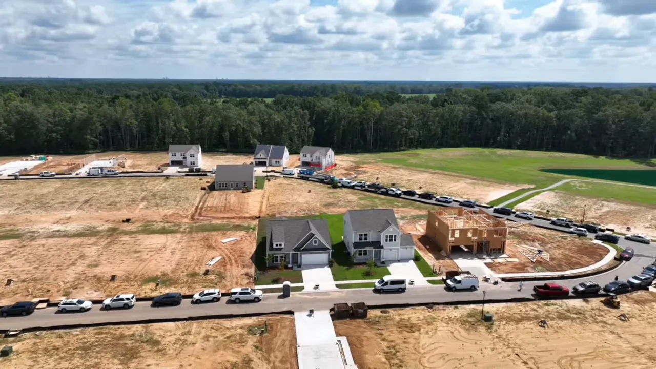 Aerial drone shot showing new homes, construction lots and streetscape at Reeves Crossing.