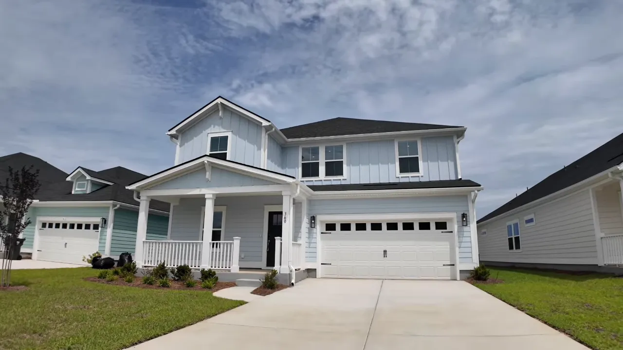 Front exterior of new construction house with covered porch and front garage