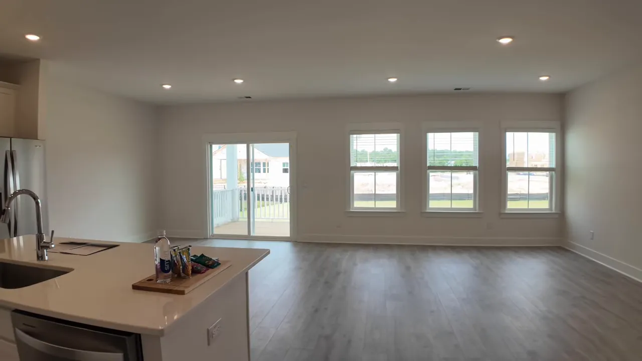 Wide view of open kitchen and living area in new construction home