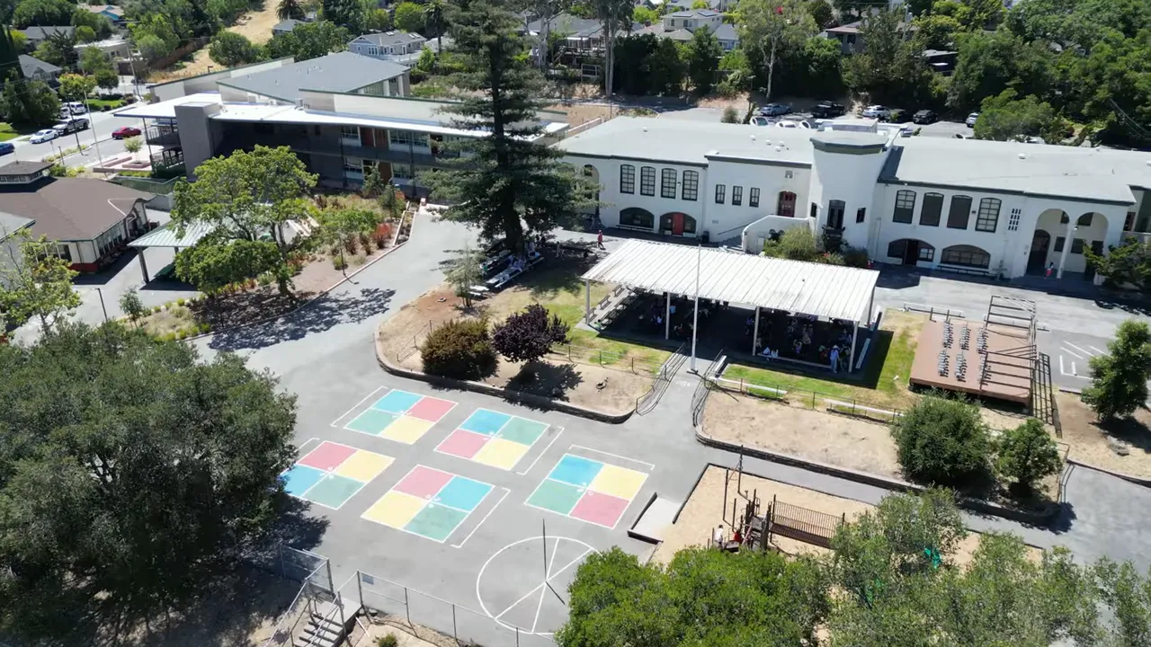 Aerial view of a Redwood City school campus with playground courts and buildings