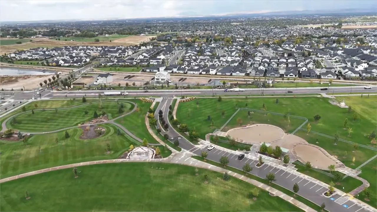 Aerial view of a Kuna Idaho neighborhood with roads, parks, and new housing development