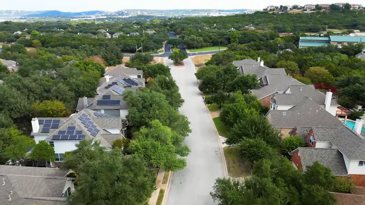 Aerial view of tree lined residential street with homes on both sides
