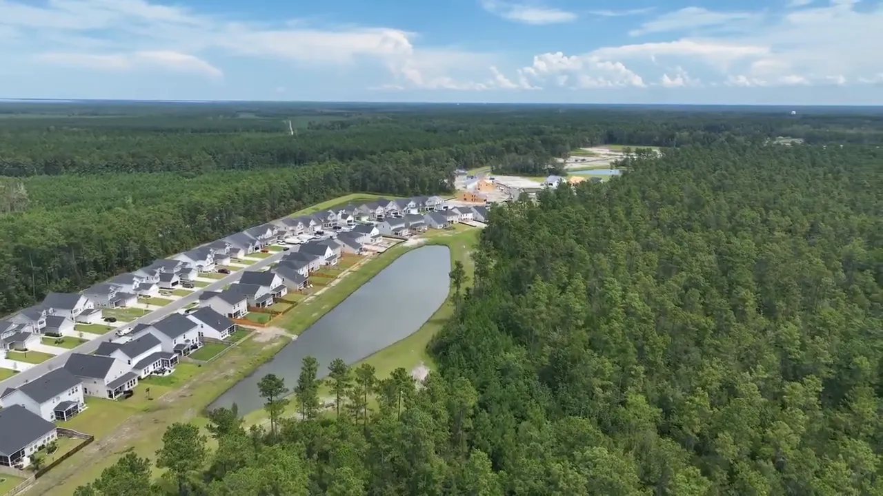 Aerial view of Cane Bay neighborhood with lake and surrounding homes