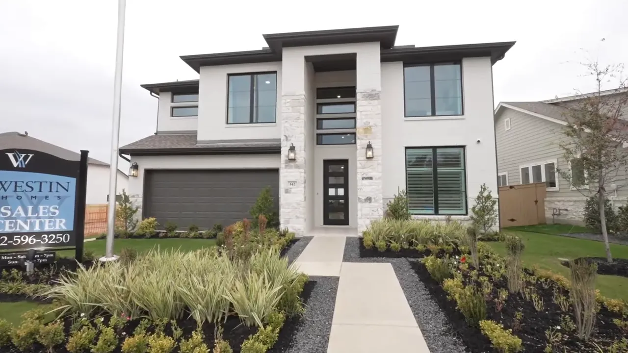Weston Homes model front entrance with sales center sign and landscaped walkway