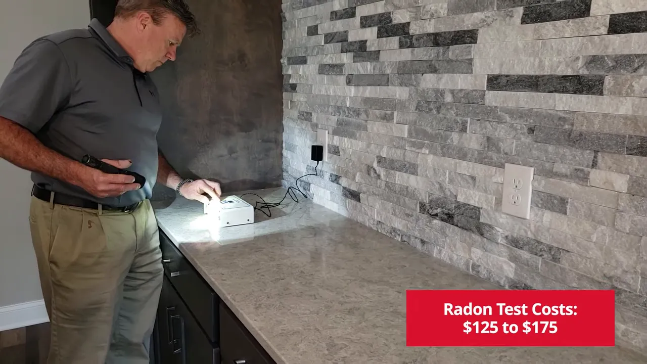 Person setting up a radon test device on a countertop with an on-screen label noting radon test costs
