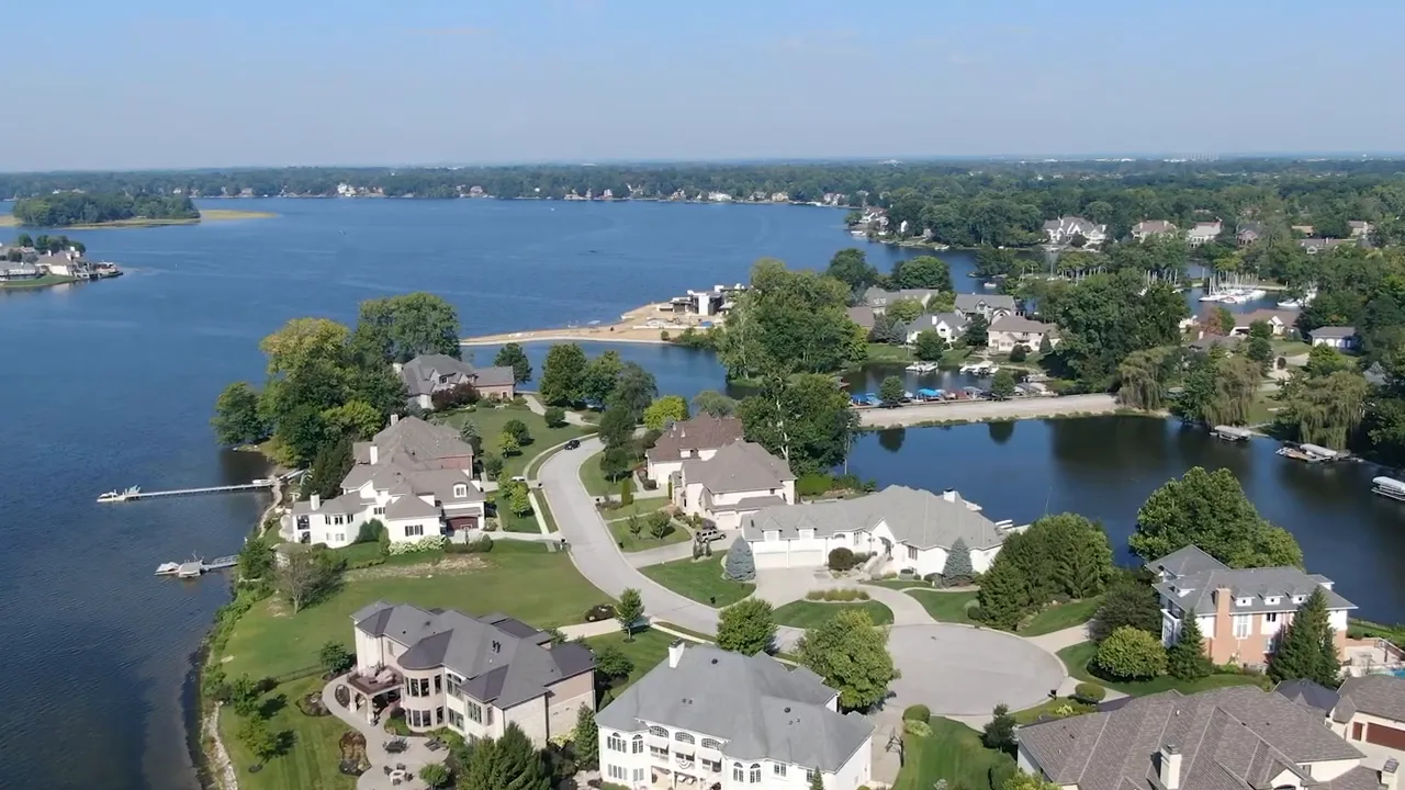 wide aerial shot of Geist Reservoir shoreline with luxury homes and docks