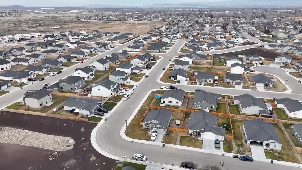 Aerial view of a large suburban neighborhood with curving streets and many homes