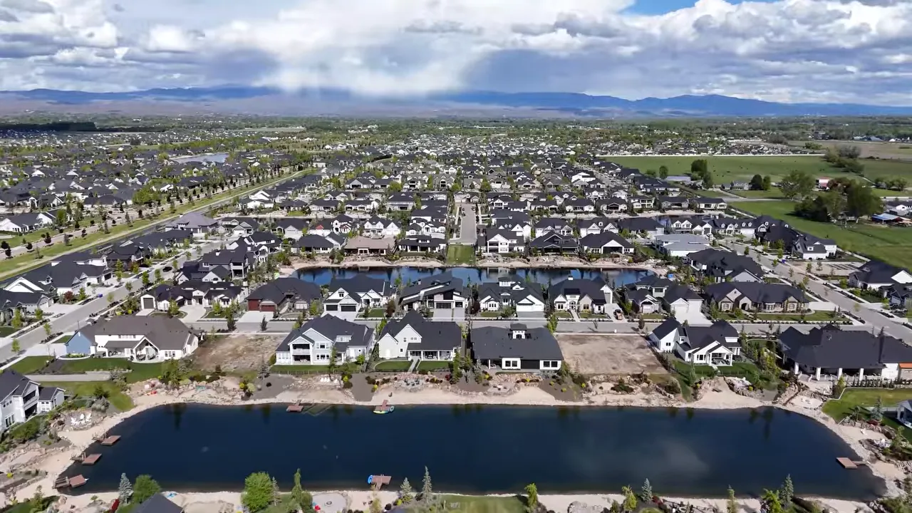 Large neighborhood with homes and ponds viewed from above