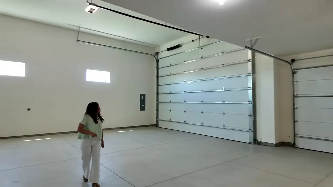 Large bright RV garage interior with multiple oversized garage doors