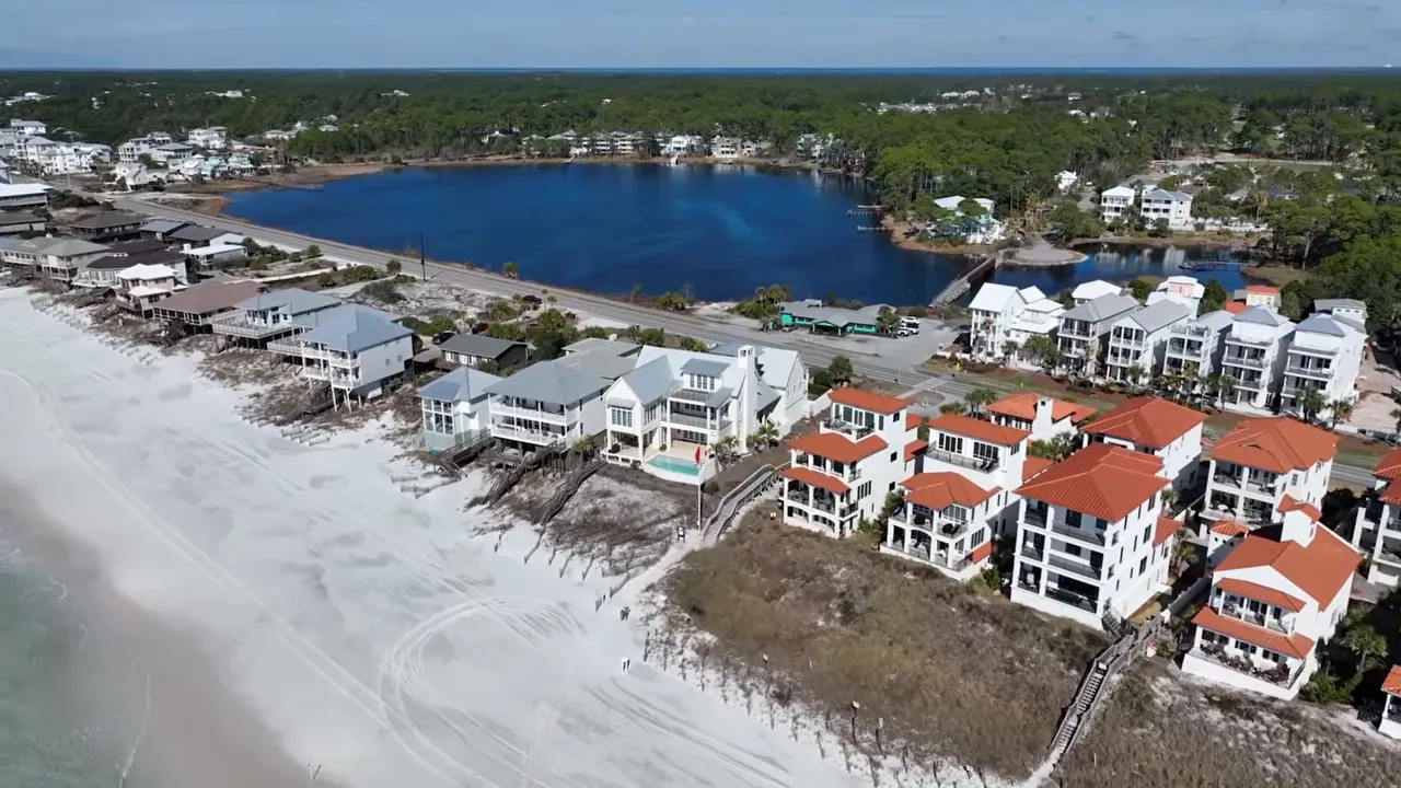 Aerial view of Florida beachfront homes beside white sand and water
