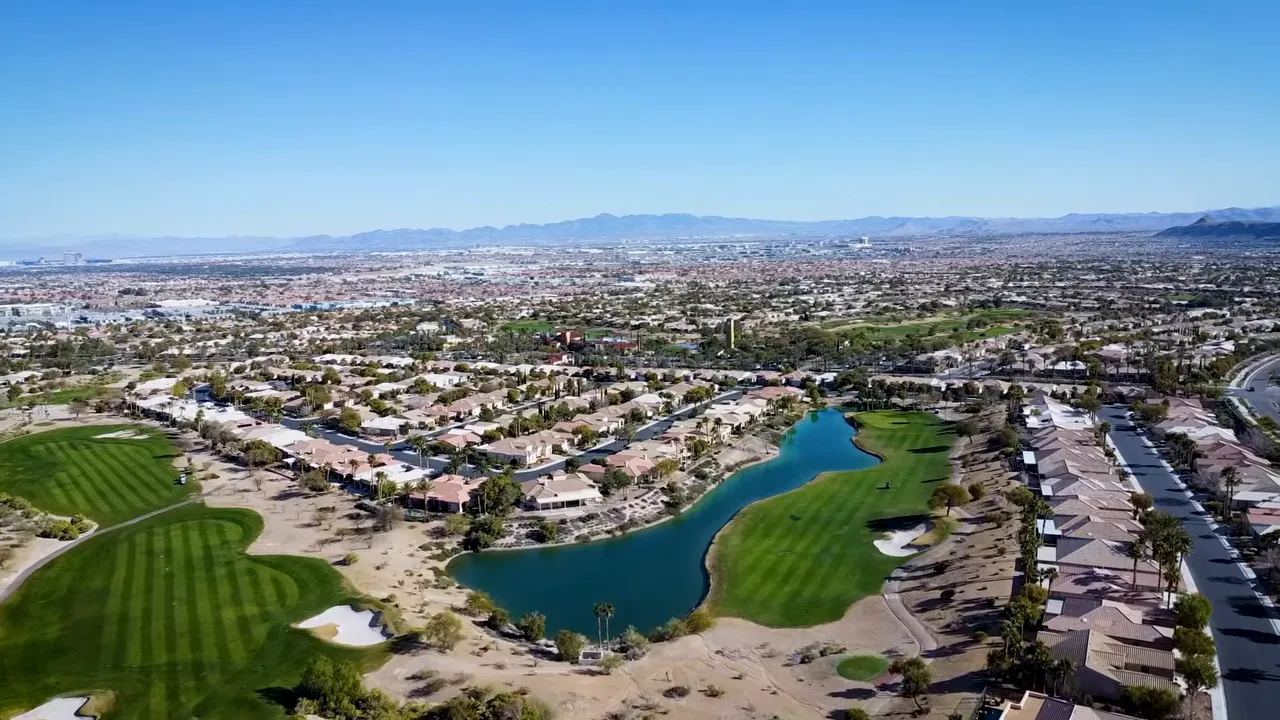 Aerial view of a Las Vegas golf course lake and surrounding neighborhoods
