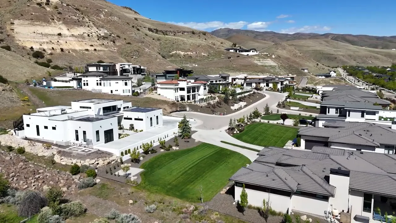 Aerial view of modern hillside homes along roads in the foothills