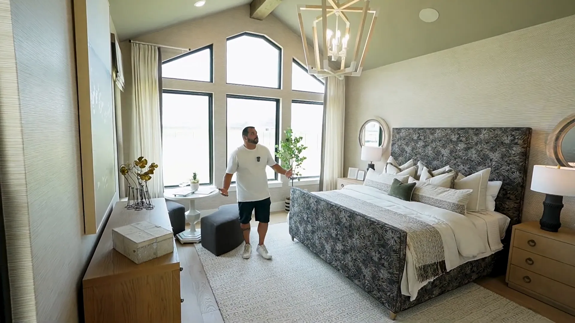 Spacious primary suite with cathedral ceilings and chandelier