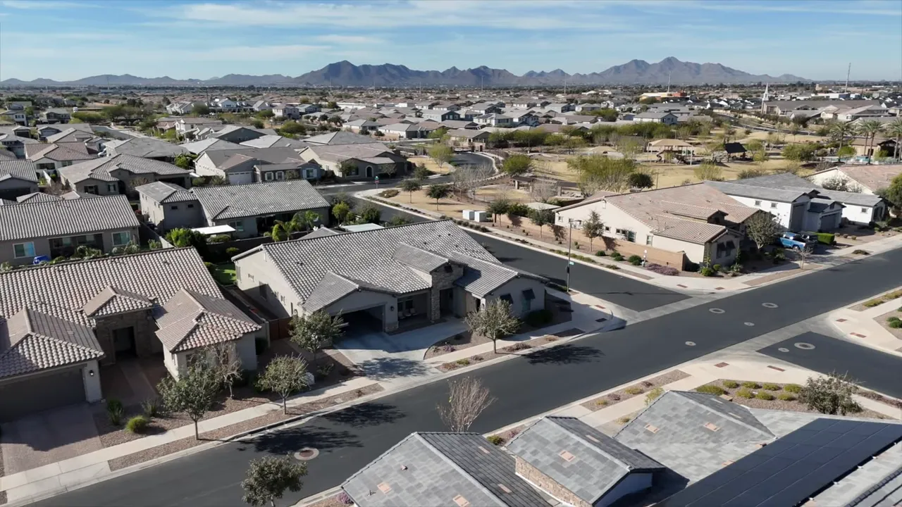 aerial view of established neighborhood streets with single-story homes and mountain views