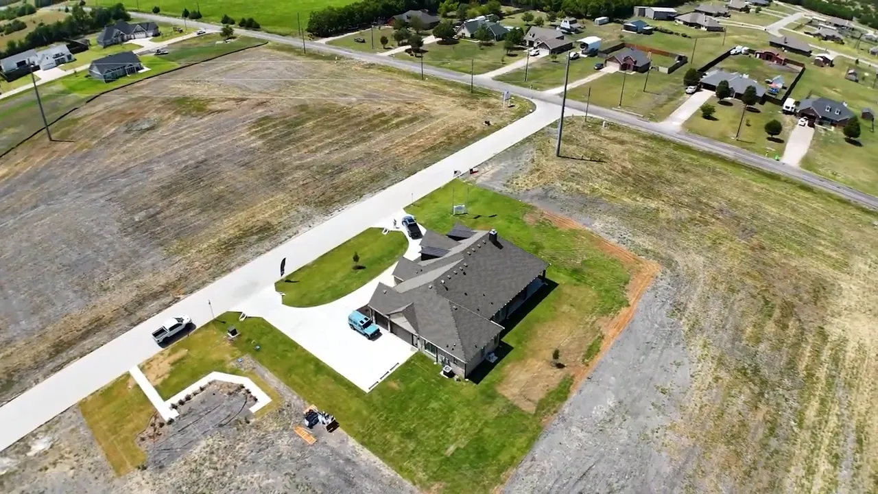 Aerial view showing model home on large lot with surrounding acreage parcels