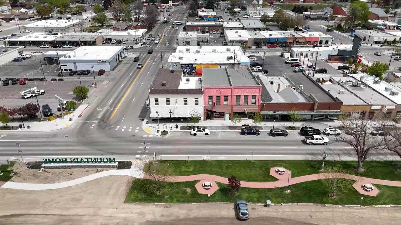 Aerial view of downtown Mountain Home with text calling it a great place for investment because it is a small town
