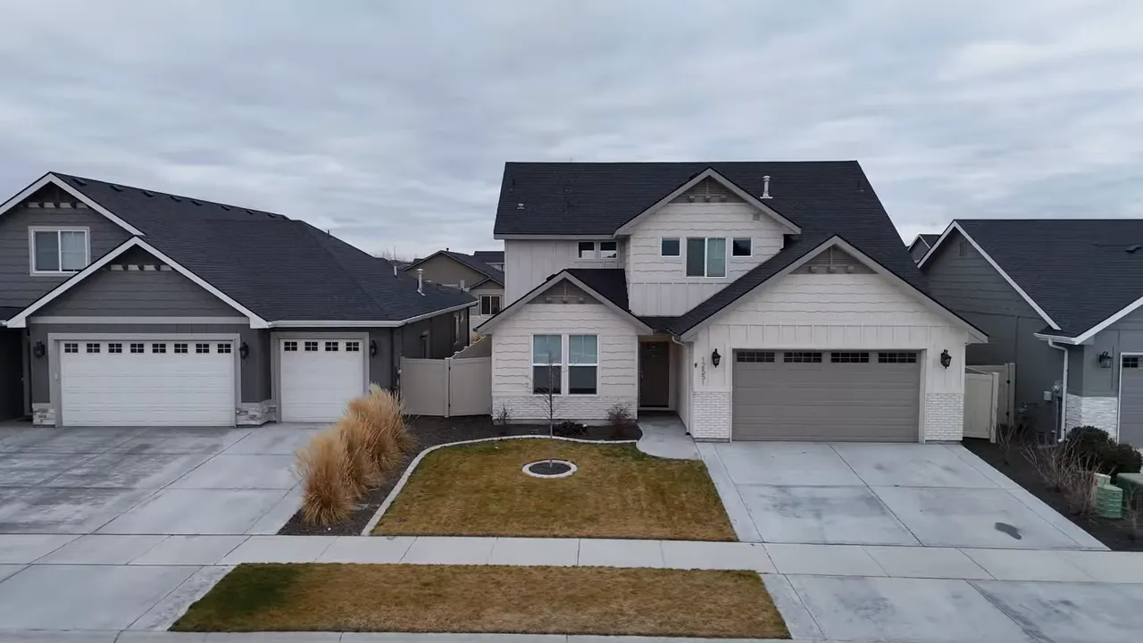 Front view of suburban homes with attached garages on a cloudy day