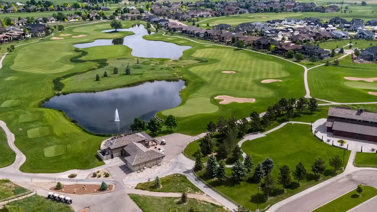 Aerial view of a golf course with ponds fairways and clubhouse