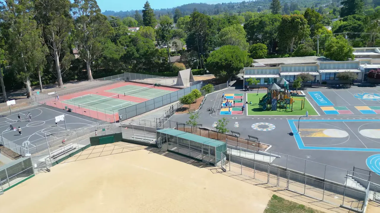 Aerial view of Peninsula schoolyard with tennis courts and playground area