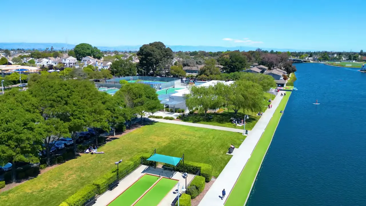 Aerial view of a Peninsula waterfront park with walking path and courts