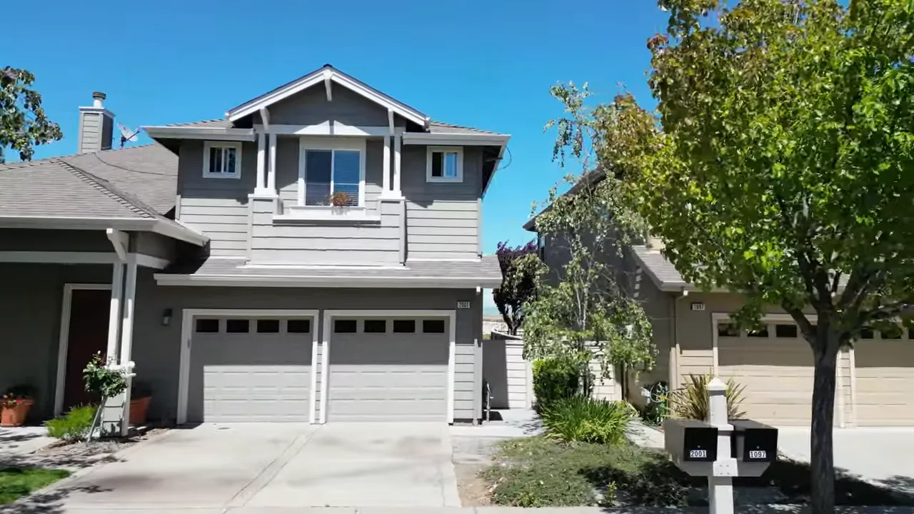 Front view of a two-story Peninsula home with an attached two-car garage