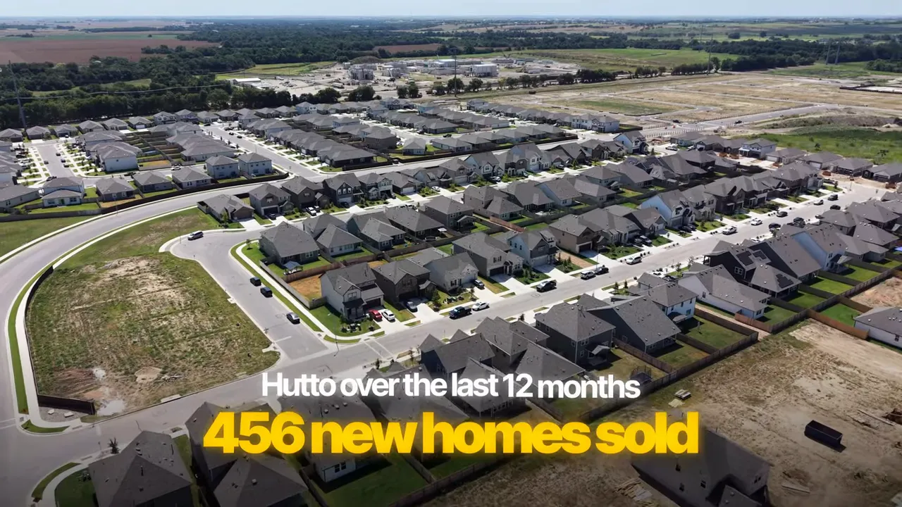 Aerial view of a Hutto neighborhood with text showing 456 new homes sold over 12 months