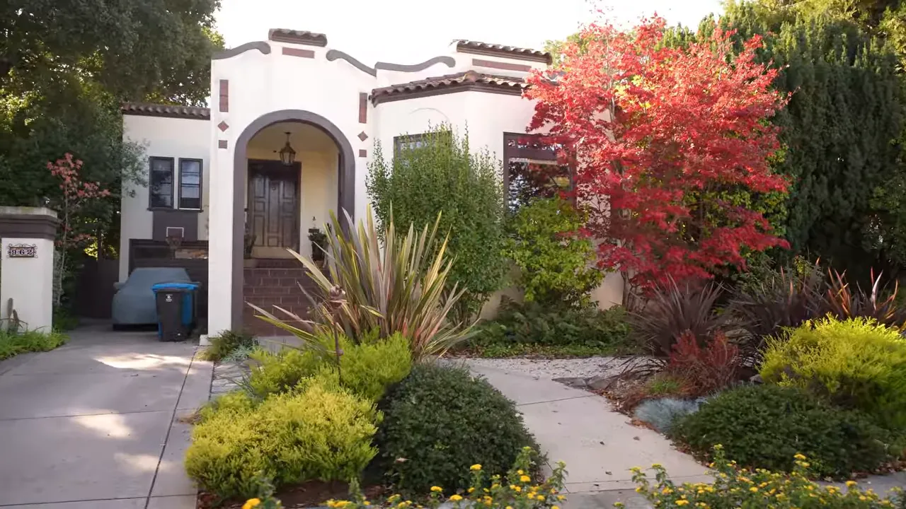 Landscaped front yard and entry walkway with flowers and mature shrubs in San Mateo, California